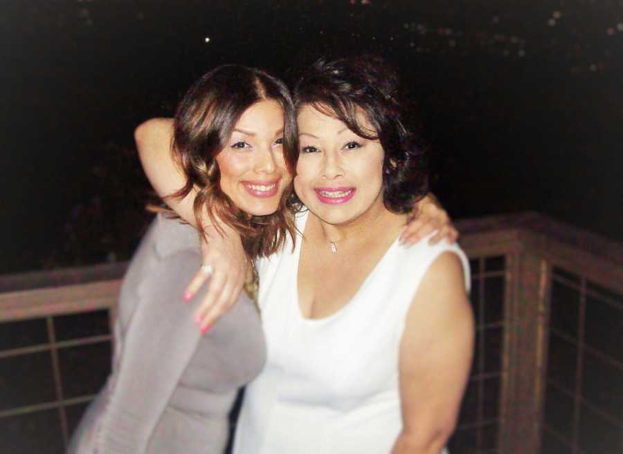 mom and daughter smiling for picture on deck