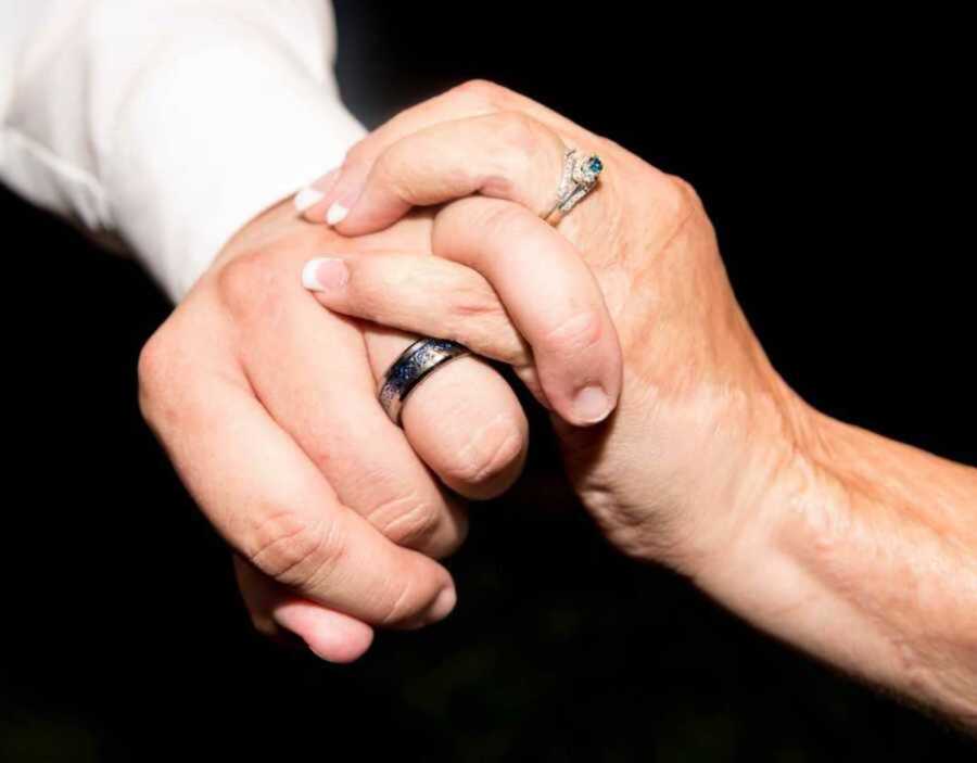 Bride and groom wearing wedding rings