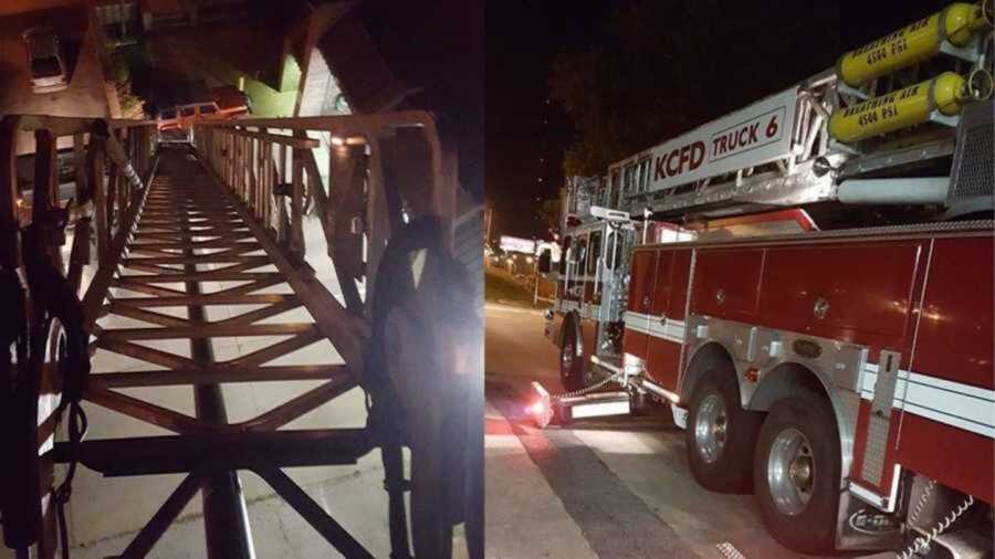 Firetruck ladder extended into night sky