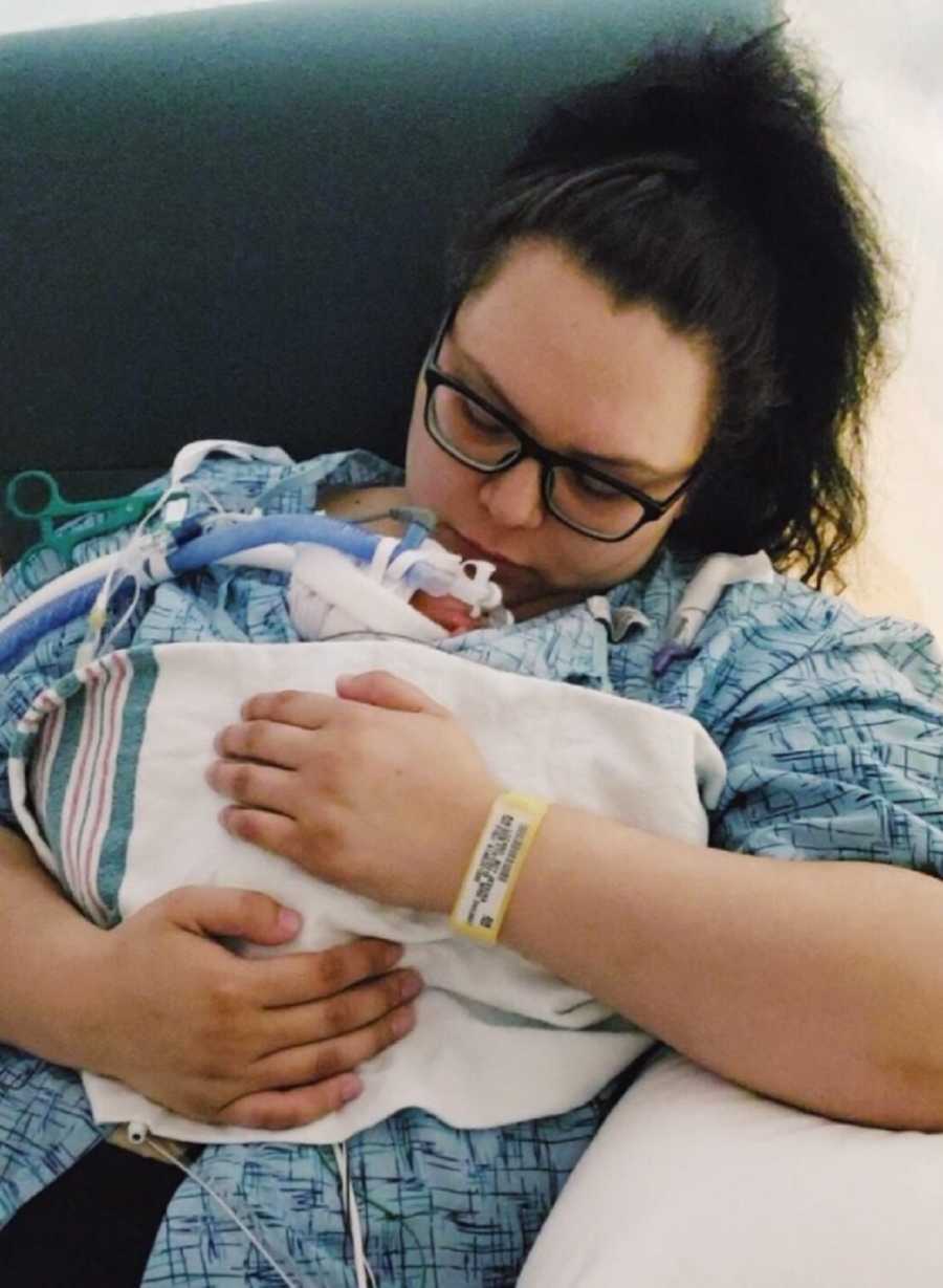Mom embracing premature newborn son