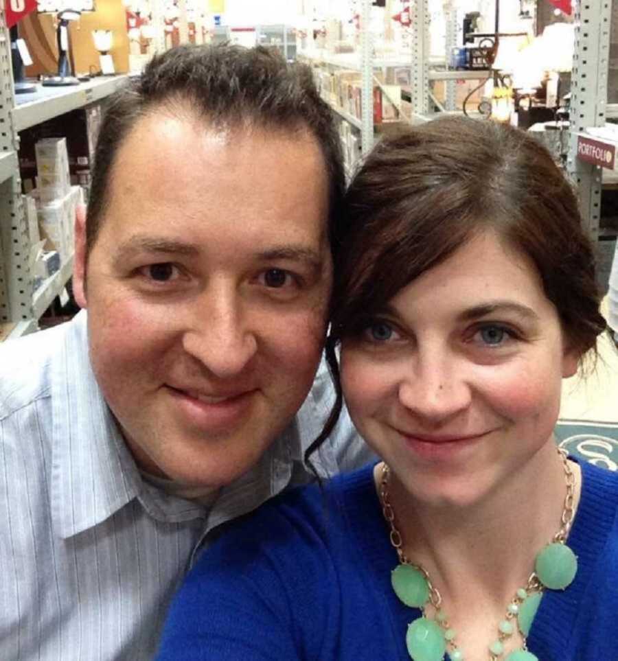 Divorced partners smiling in store aisle