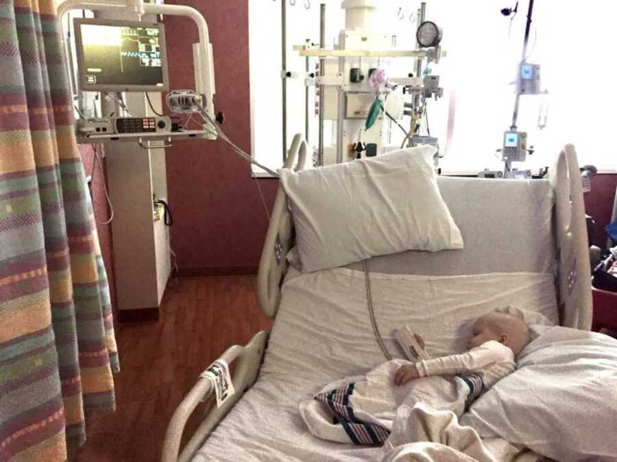 Girl with leukemia lying in hospital bed