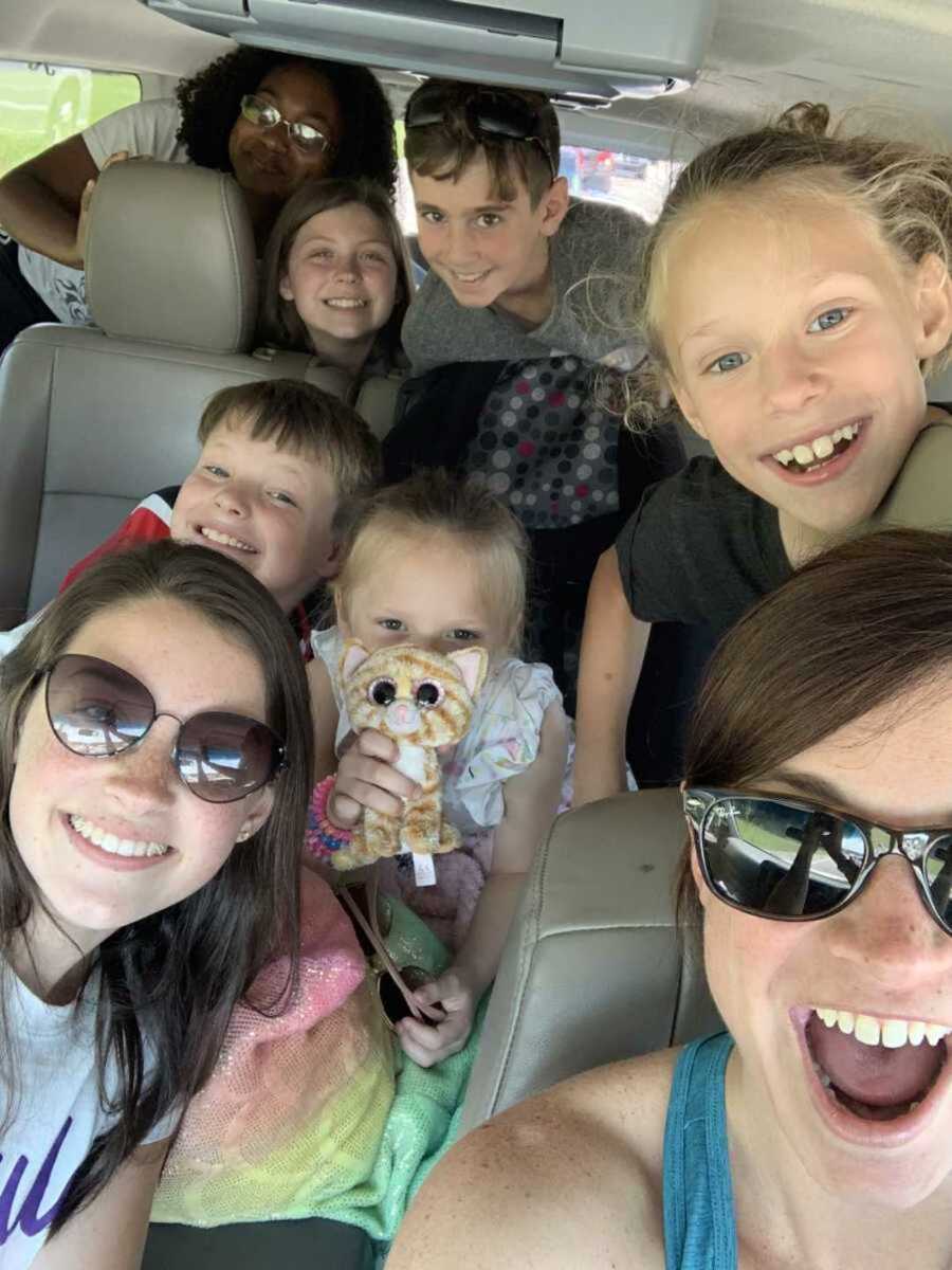 Foster mom driving multiple foster kids in mini van