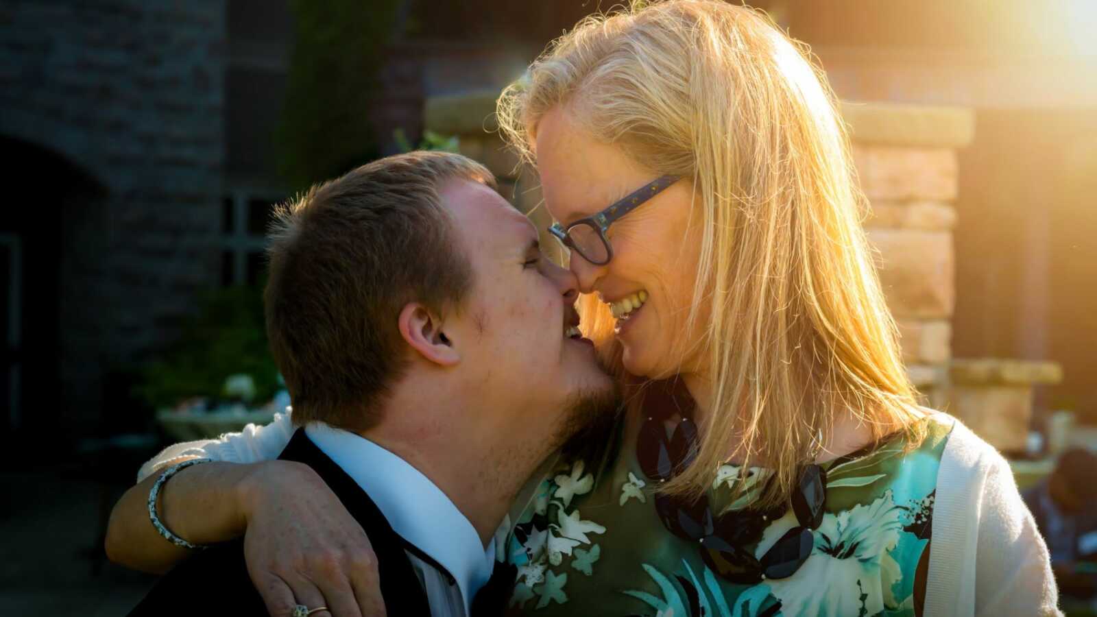 Special needs mom hugs son with Down syndrome