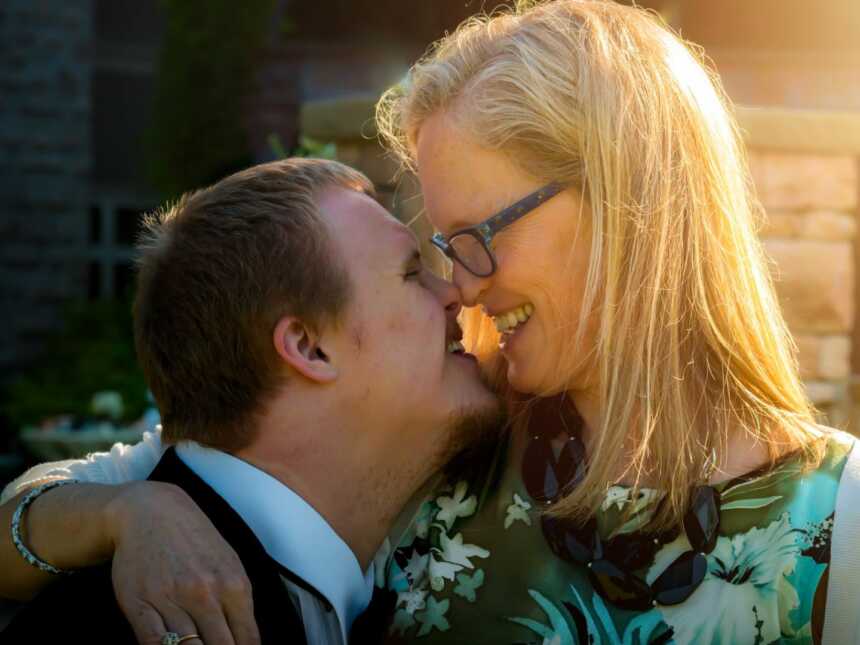 Special needs mom hugs son with Down syndrome