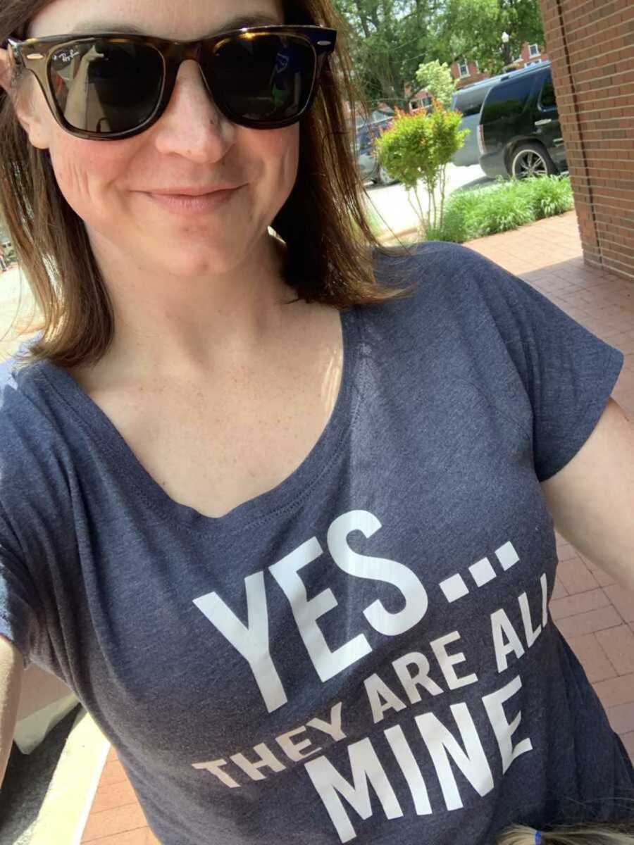 Mom in blue shirt that says "yes they are all mine"