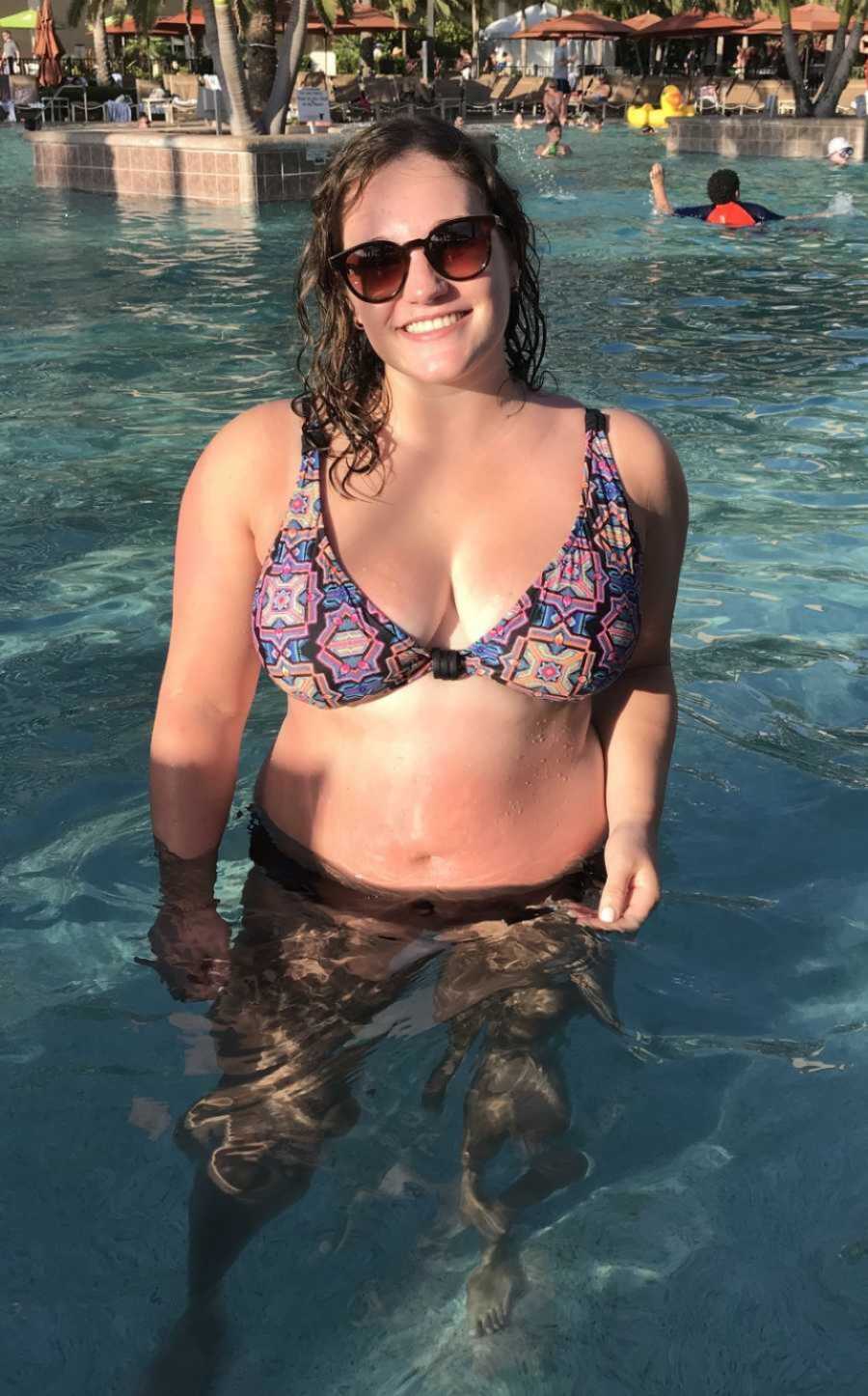 woman in a pool taking a selfie