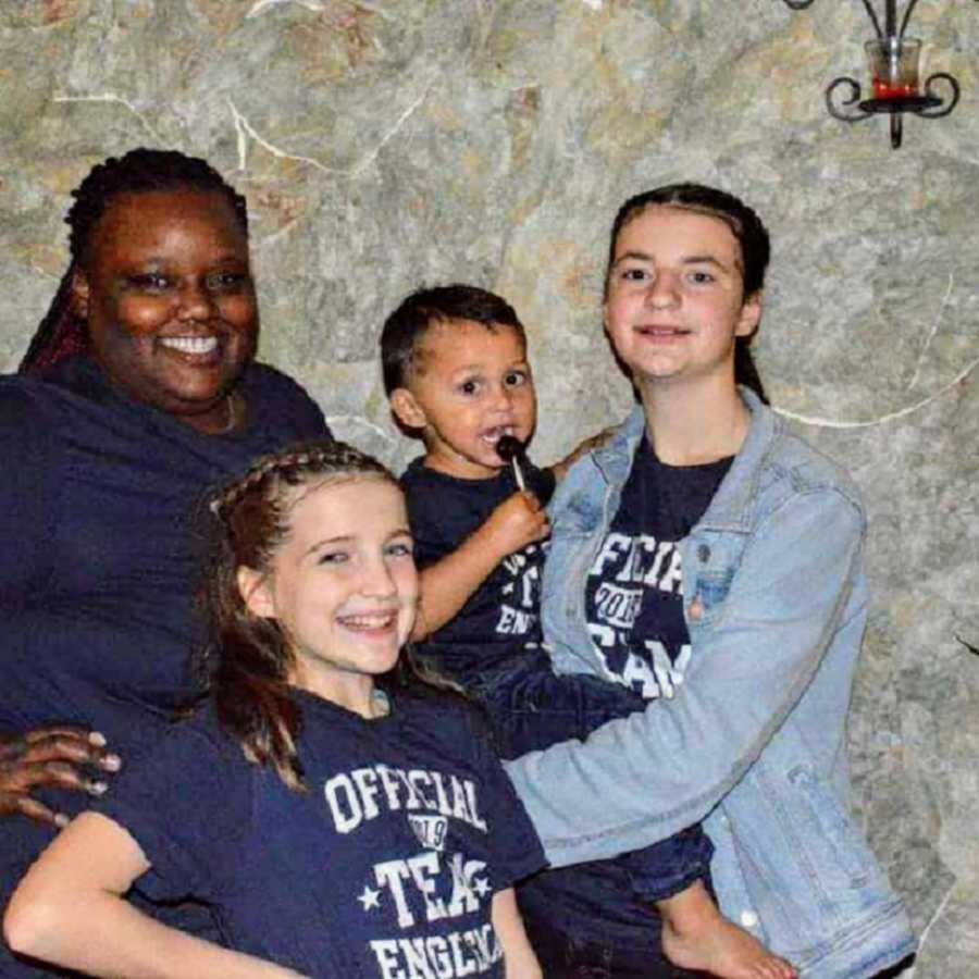 Adoptive family in matching blue shirts