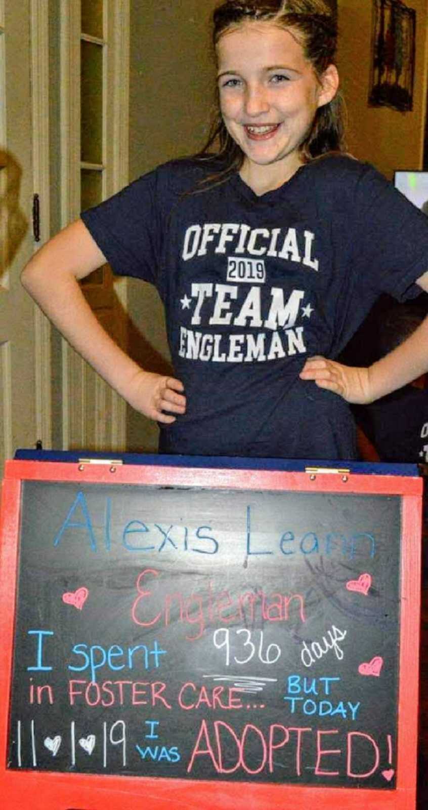 Adoptive daughter poses with chalkboard