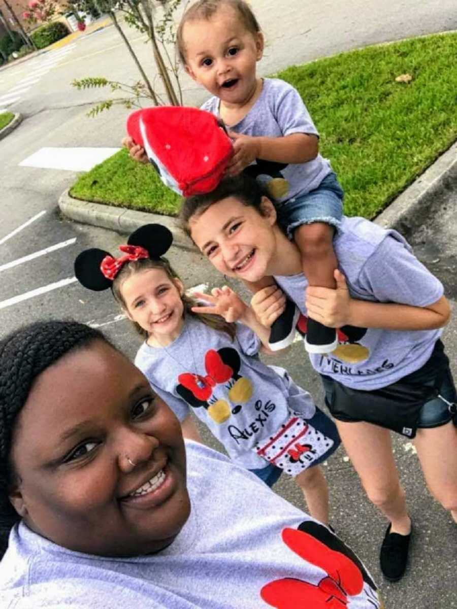 Adoptive family wearing matching Disney shirts