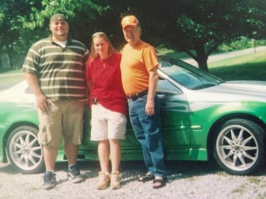 young woman and boyfriend with father standing in front of car