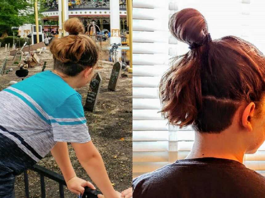 boy stands with long hair in bun