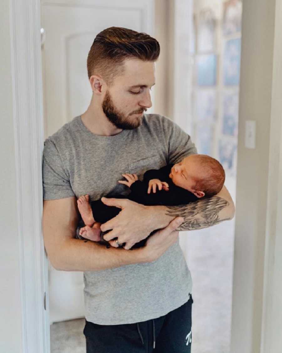 new dad holding newborn baby boy