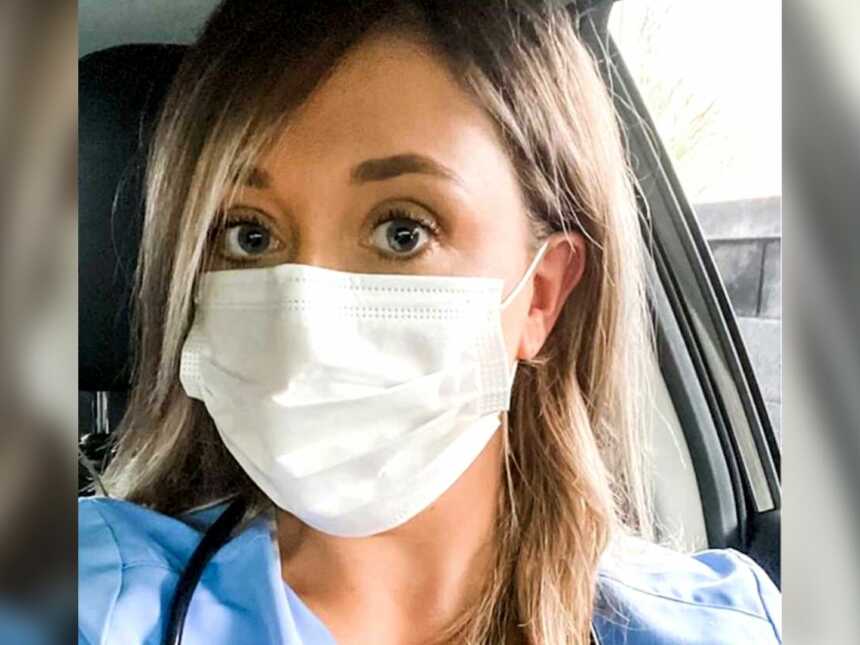 Nurse in scrubs wearing white mask