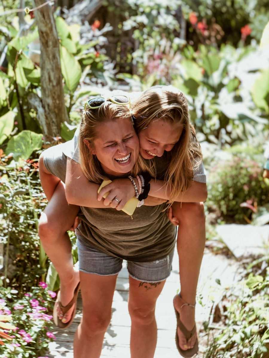 adoptee and birth mother holds her daughter she put up for adoption on her back