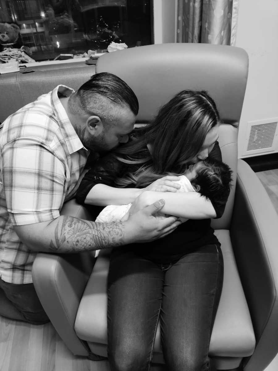 Parents hold their dead baby for a final time. 