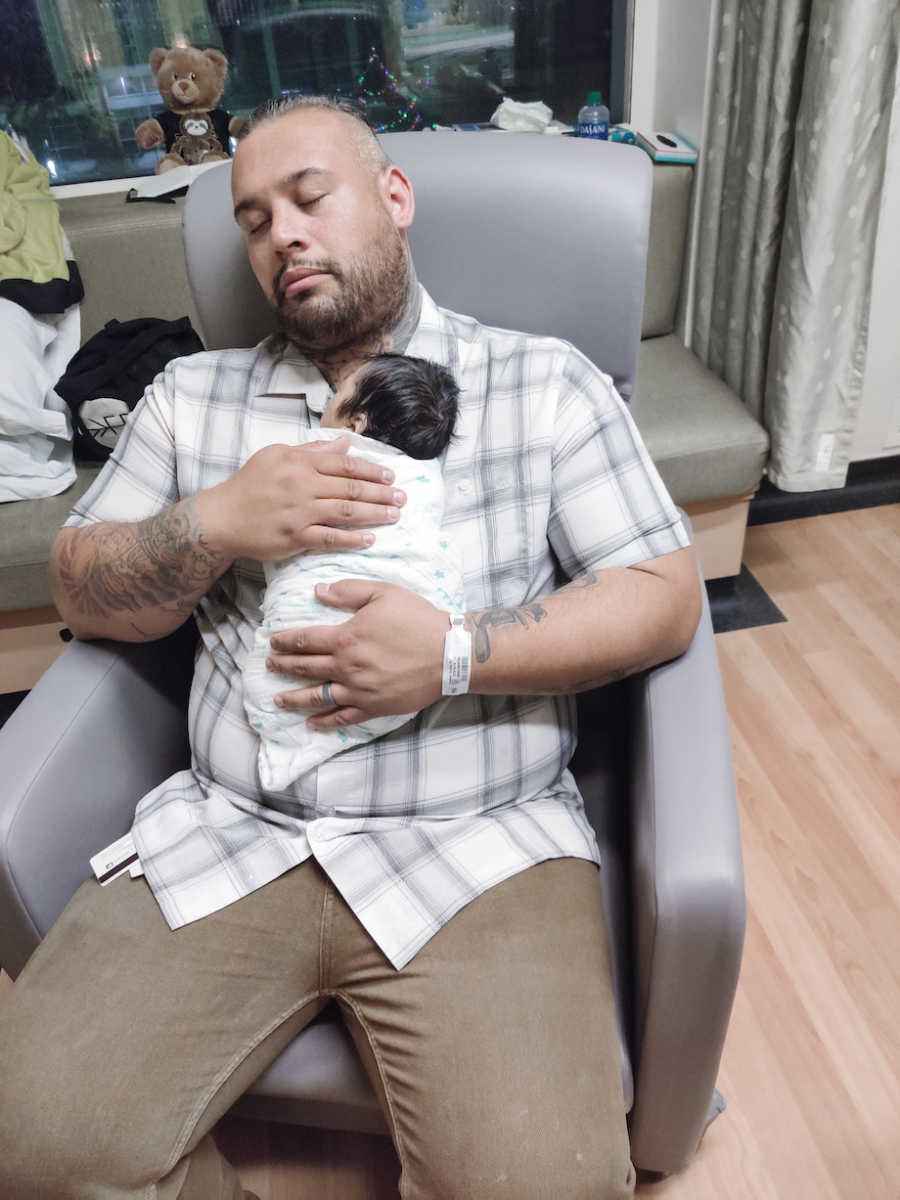 Grieving dad holds baby boy one last time. 