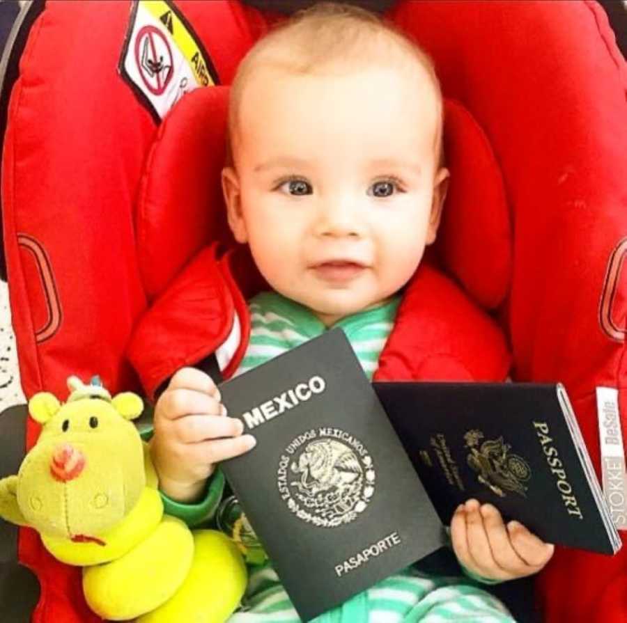 Infant in green footie pajamas holds Mexican passports