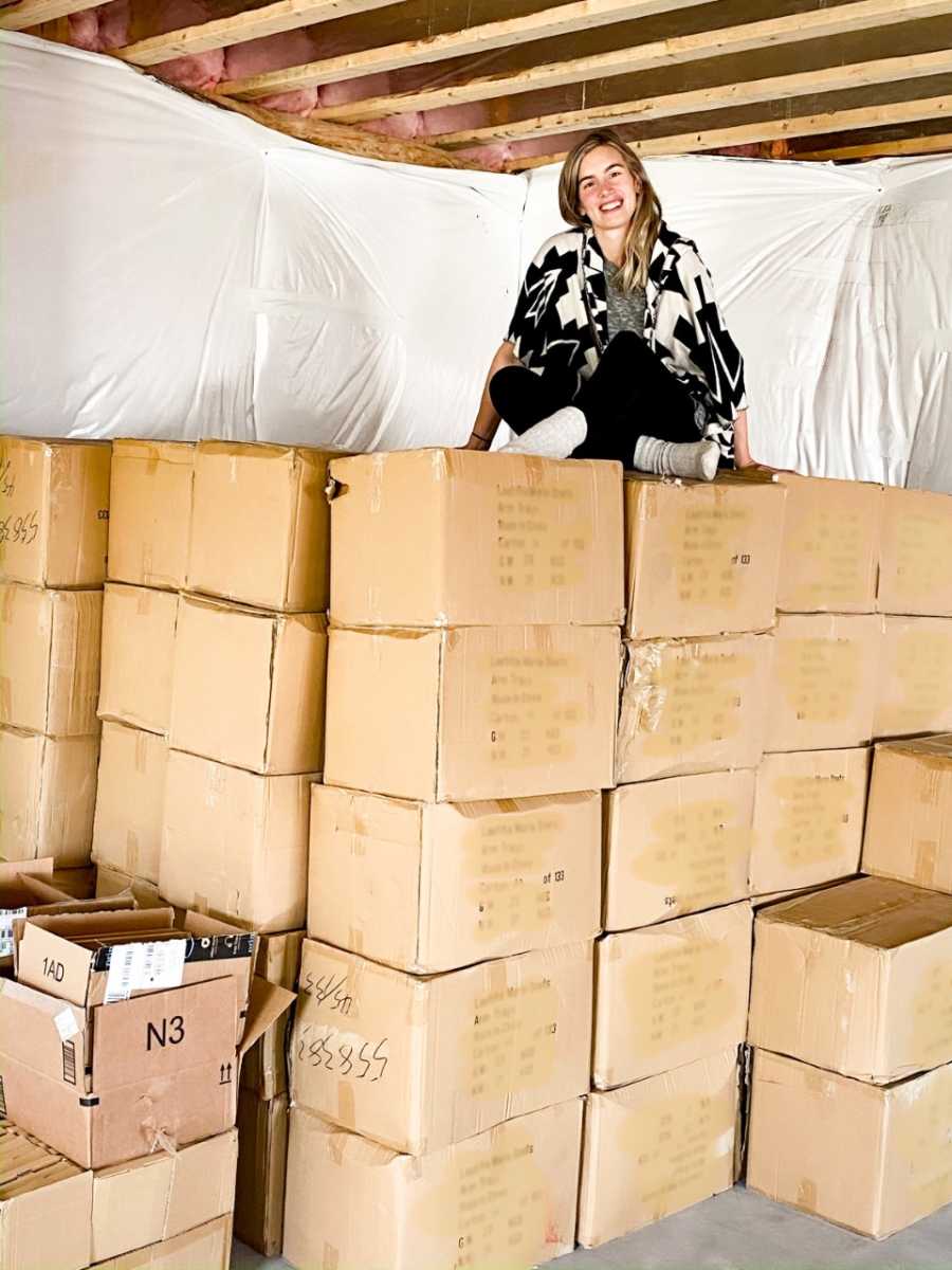 Teen mom sits on mountain of brown packages