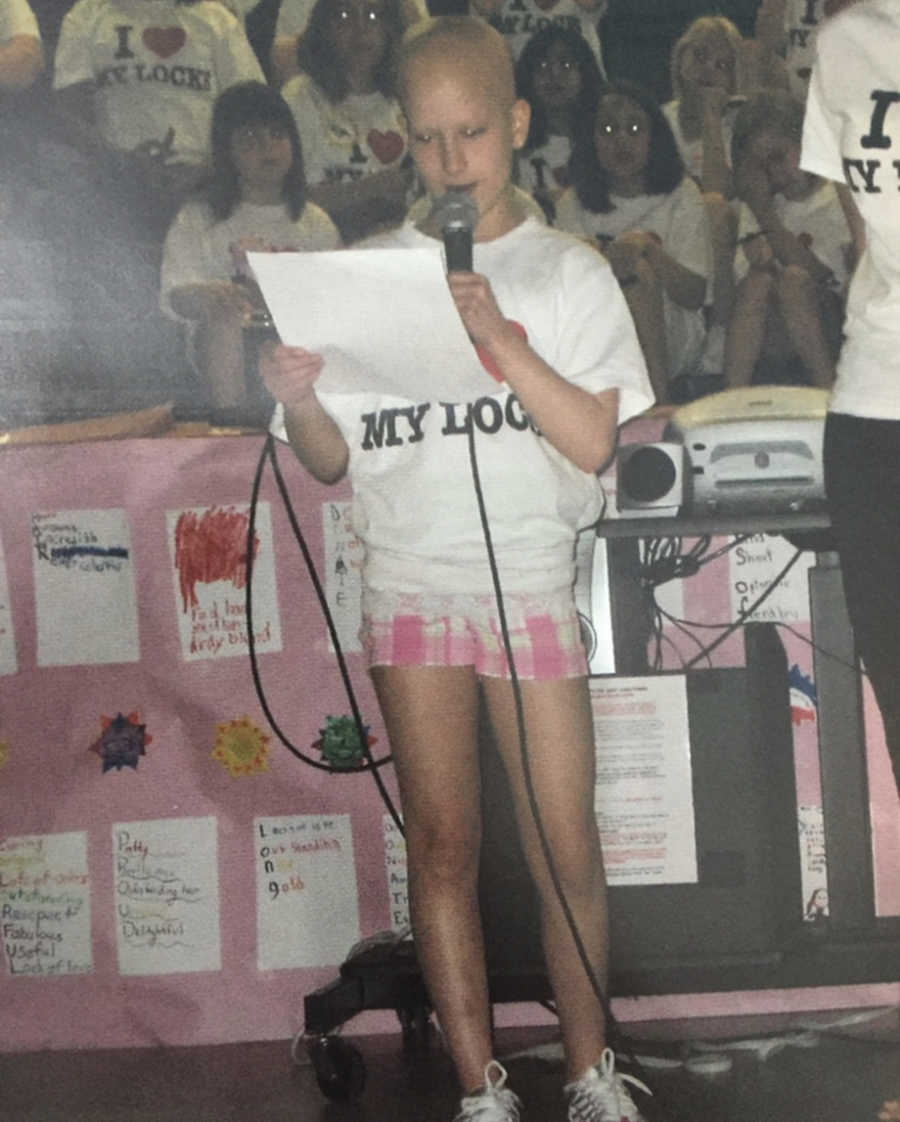 Girl with alopecia speaking at school assembly