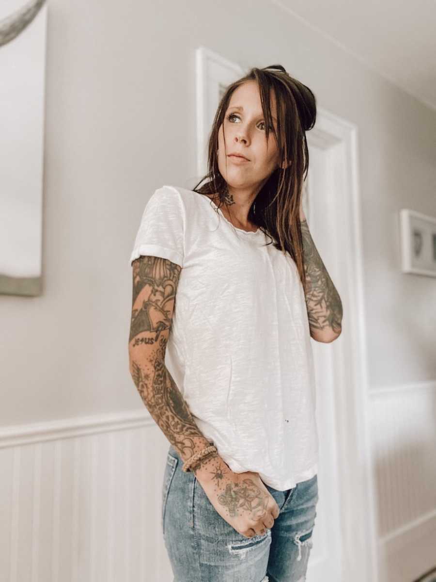 Tattooed woman in white shirt