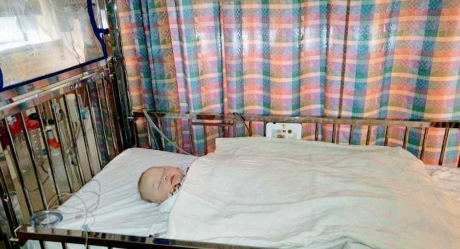 A young boy with down syndrome lies down in the hospital during testing