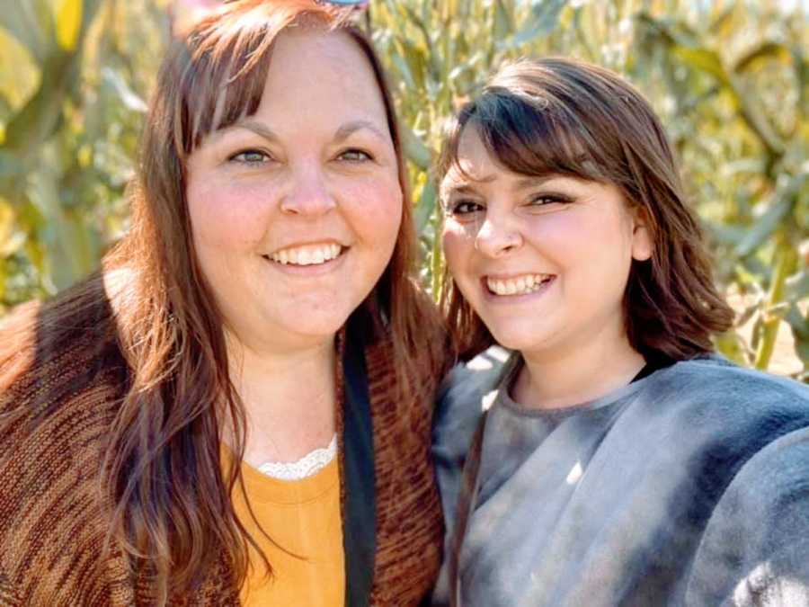 Woman takes a selfie with her mom outside during a walk