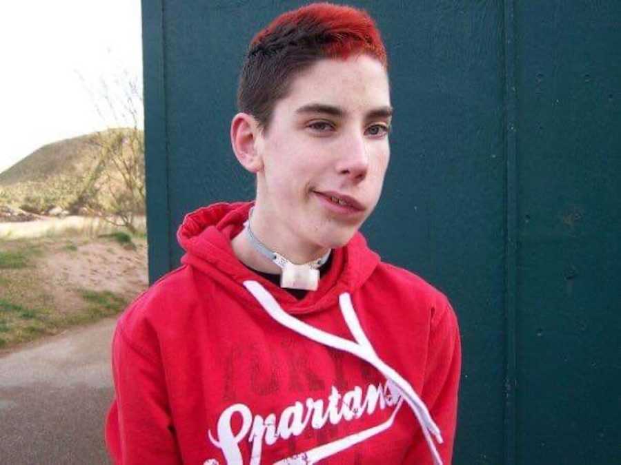 Boy with dyed red hair smiling