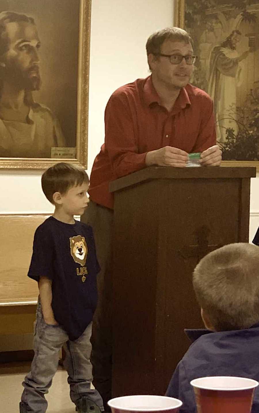 Dad and his son speaking at podium