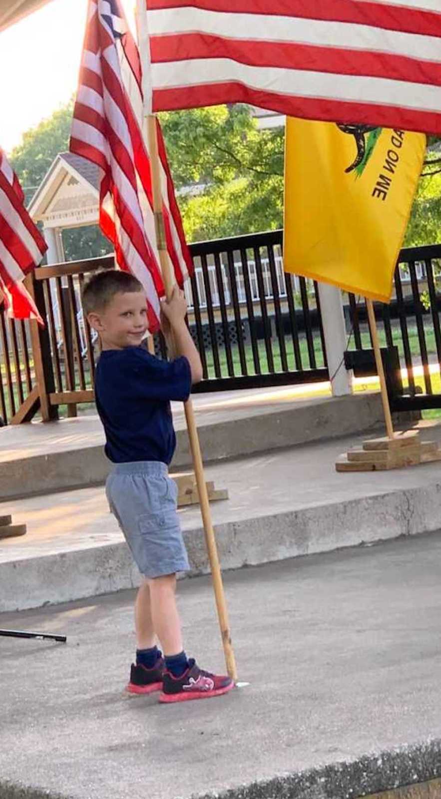 A little boy with a flag