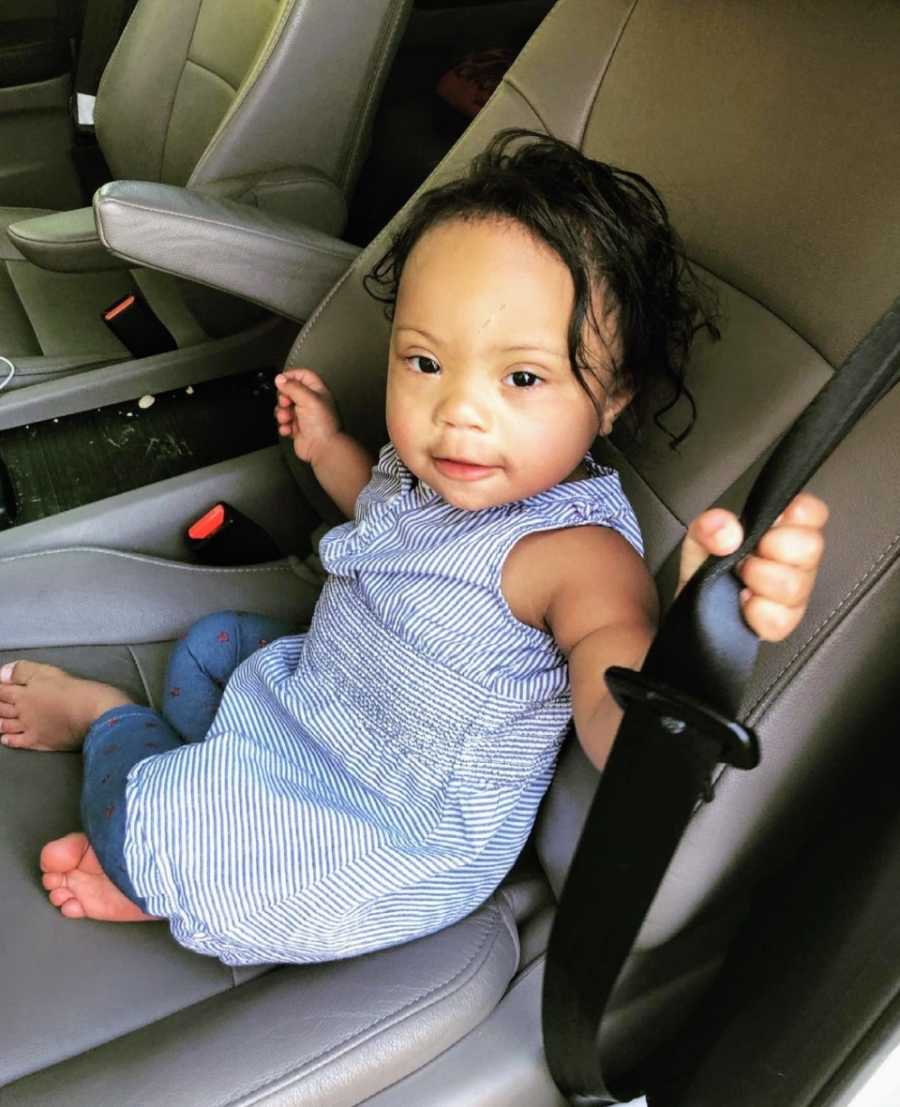 Baby girl wearing blue sitting in car