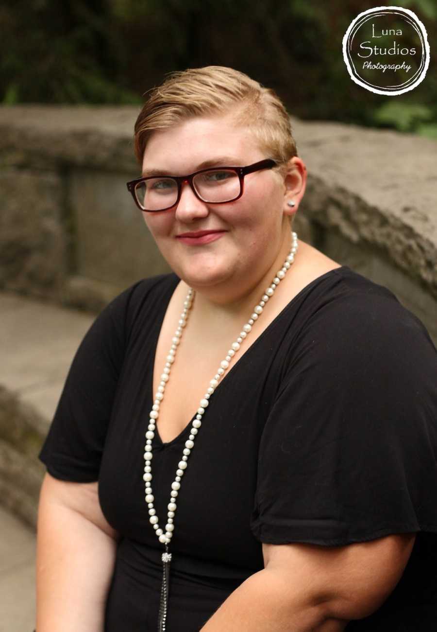 Woman posing with pearl necklace and glasses