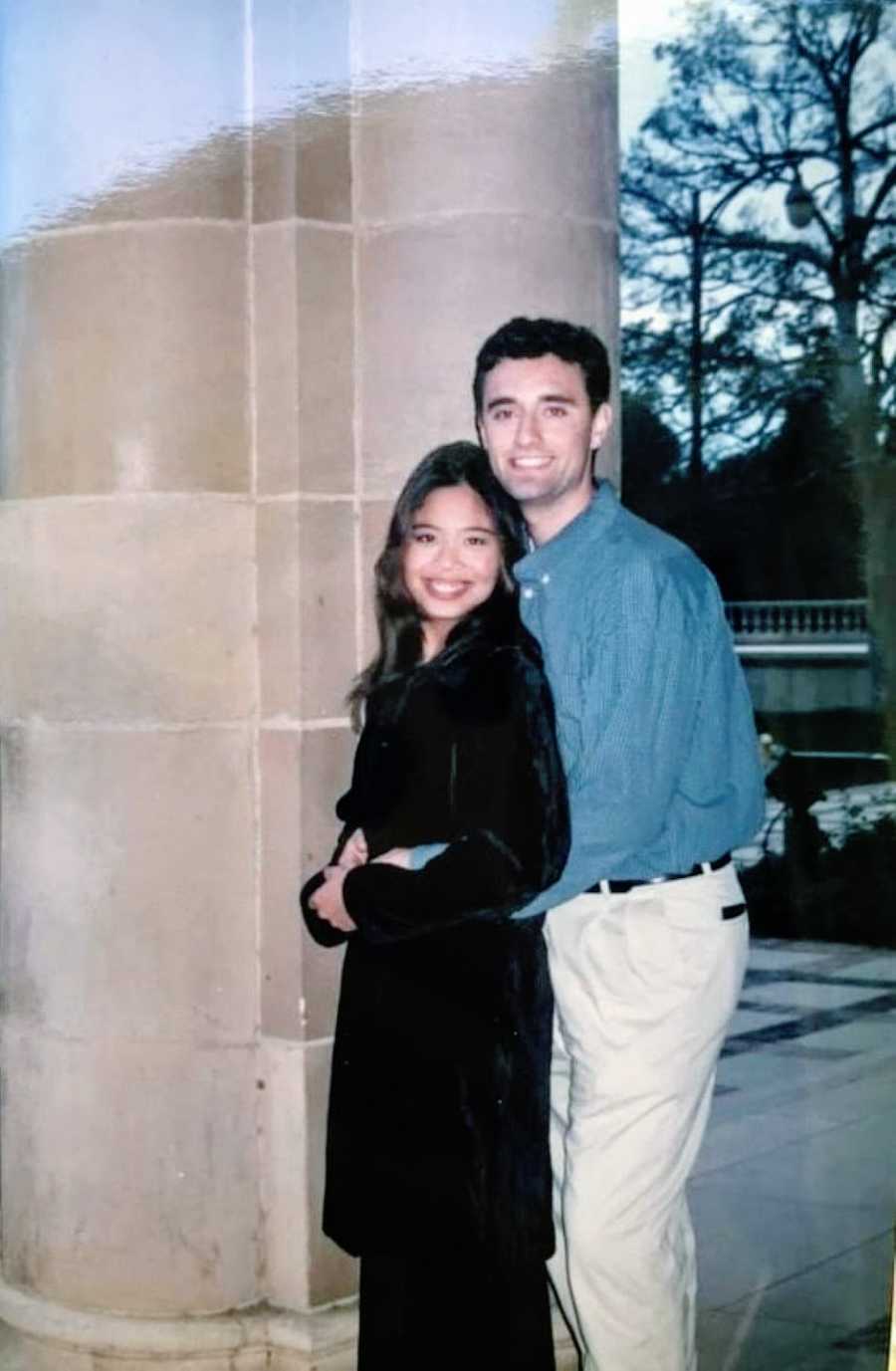 College student battling an eating disorder poses with her then boyfriend outside of a school building