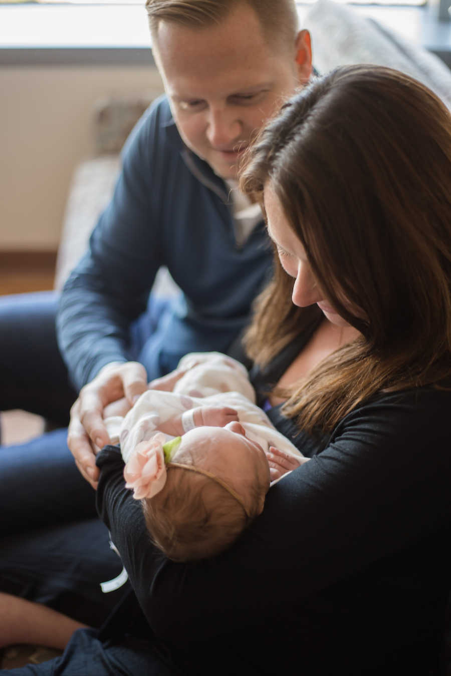 Parents holding newborn daughter