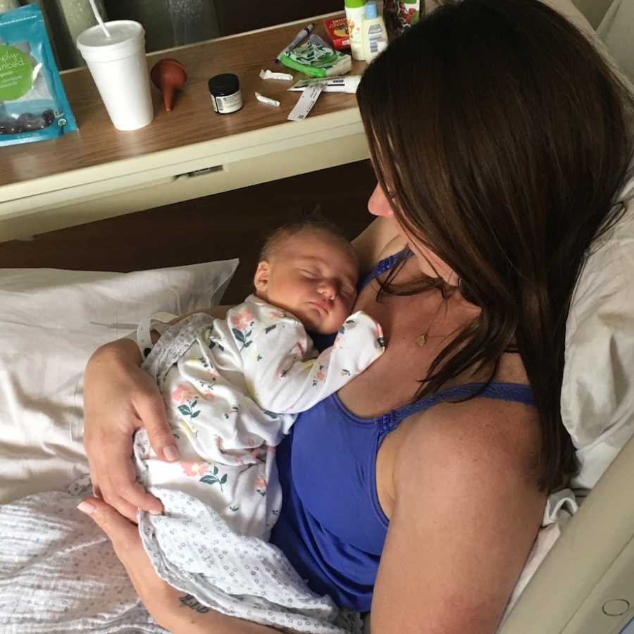 Mom holding newborn daughter in hospital