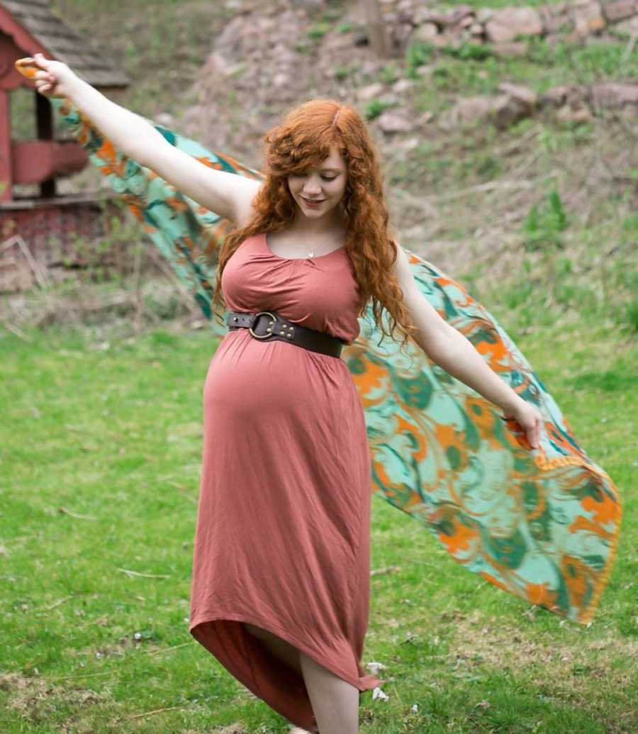 pregnant woman outside in pink dress