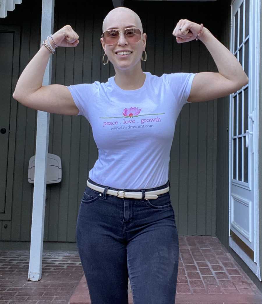 bald woman flexing arms