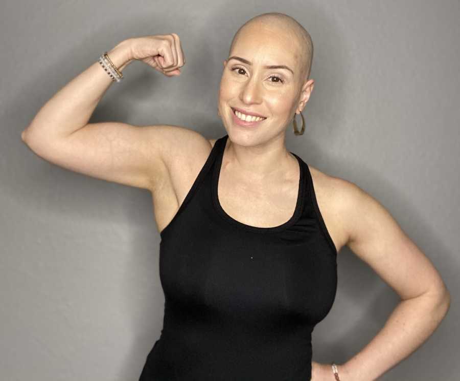 bald woman flexing arm