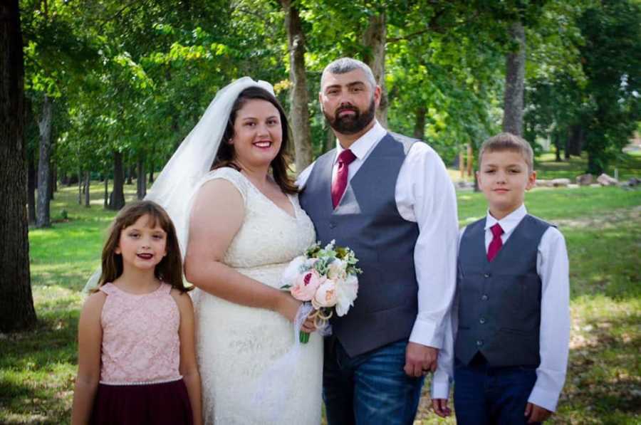 bride and groom with family on wedding day