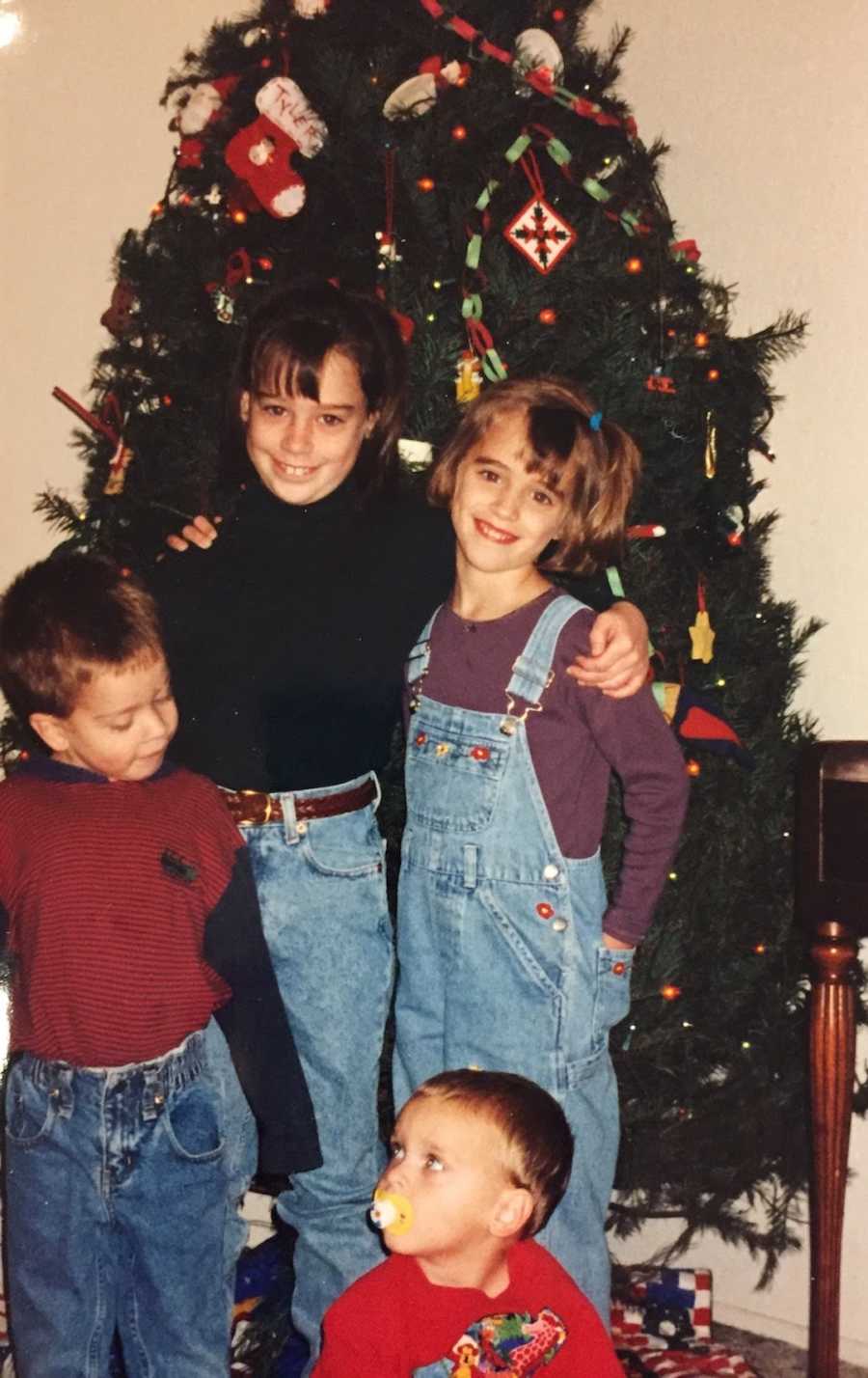 family in front of Christmas tree