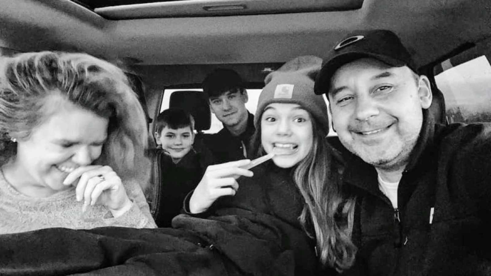 Family of five take a candid car selfie with going on a roadtrip