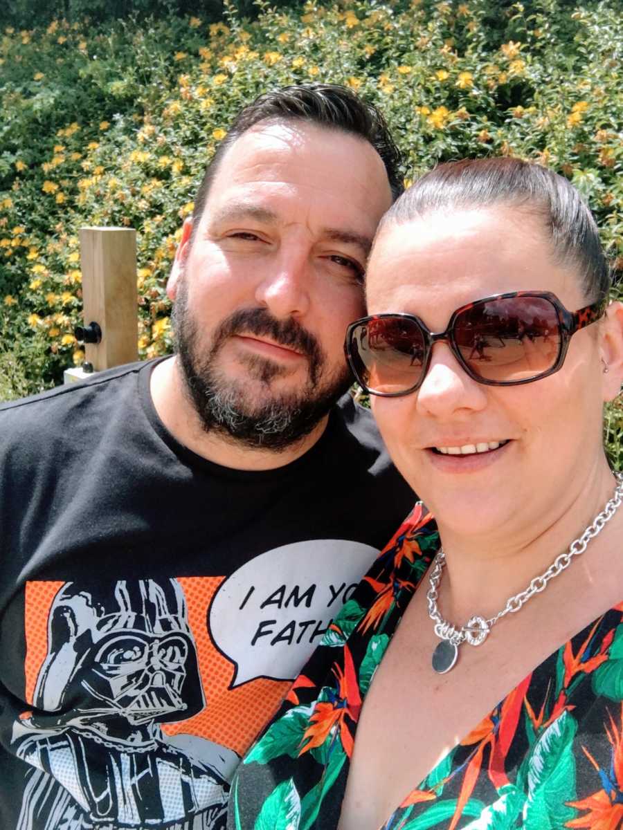 Couple take selfie outside, husband wearing a popart Darth Vader "I am your father" shirt