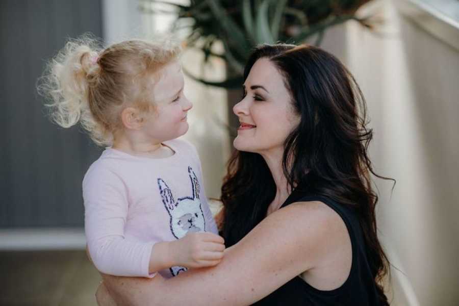 Mother and daughter looking into each other's eyes and smiling