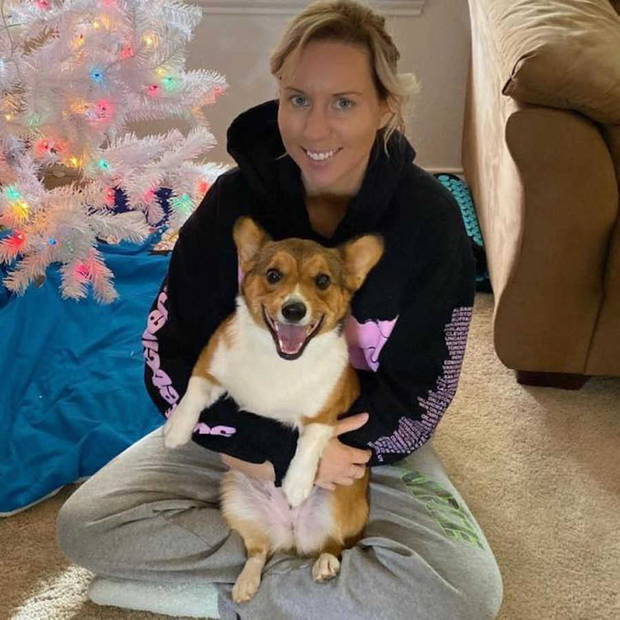 woman holding her corgi