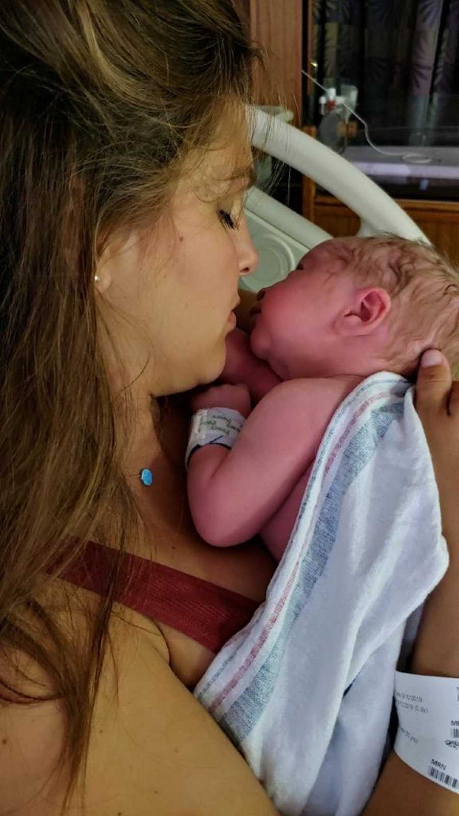 Mom holding newborn in hospital 