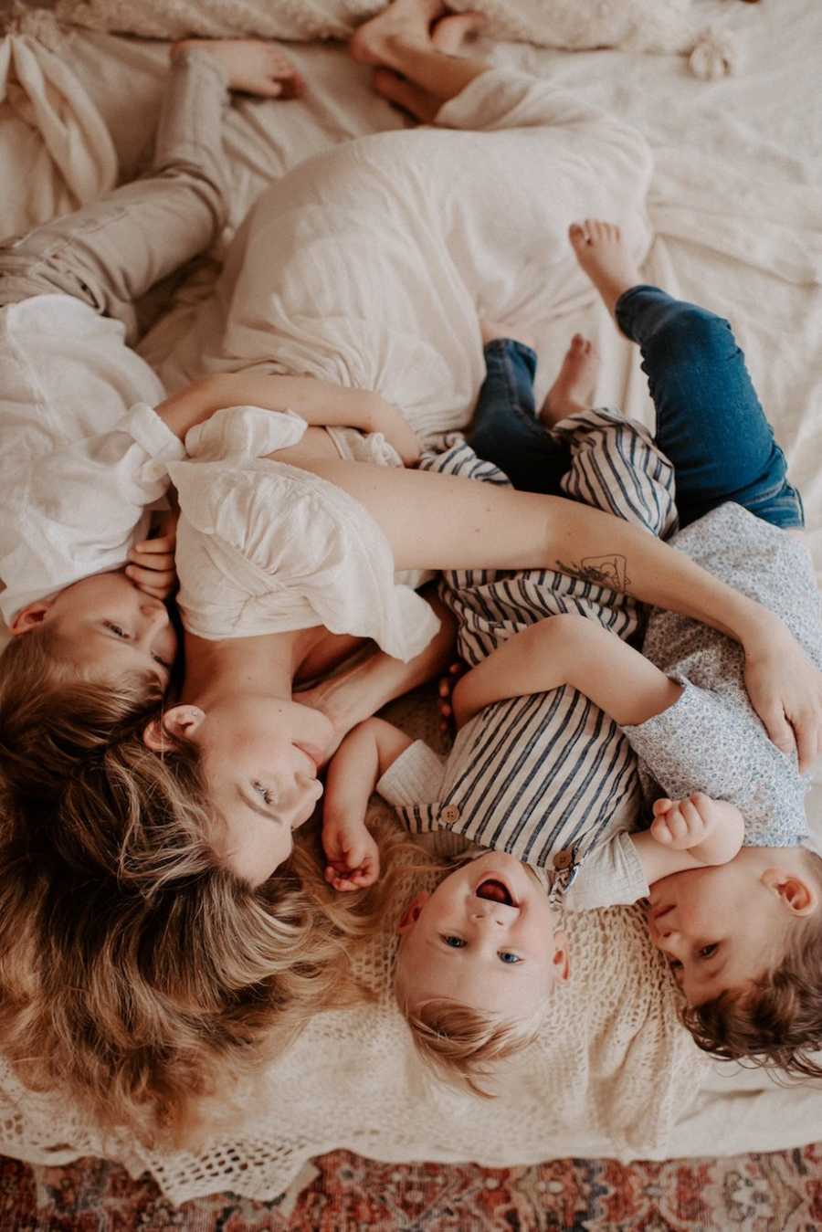 Family hugging in bed