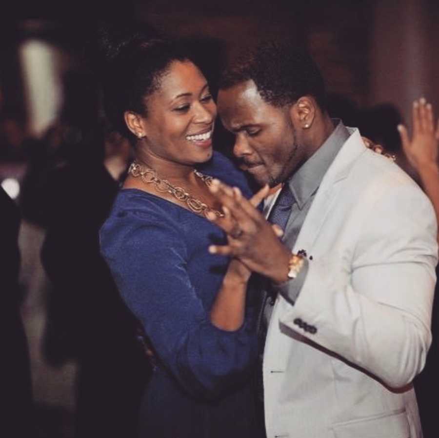 Woman and man holding hands and dancing surrounded by people