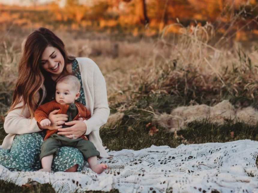 Mom holds her baby son during a beautiful Boho-themed photoshoot