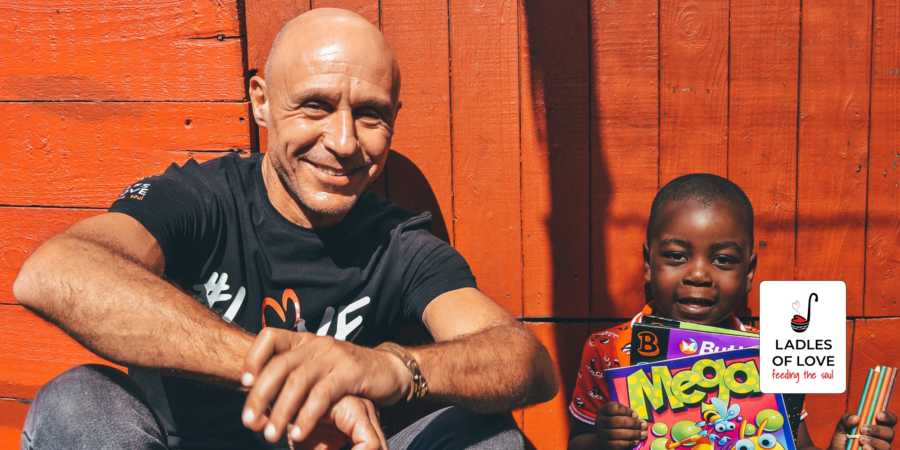 Man and boy sitting in front of a wall