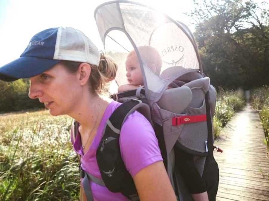 Woman hiking with baby in backpack